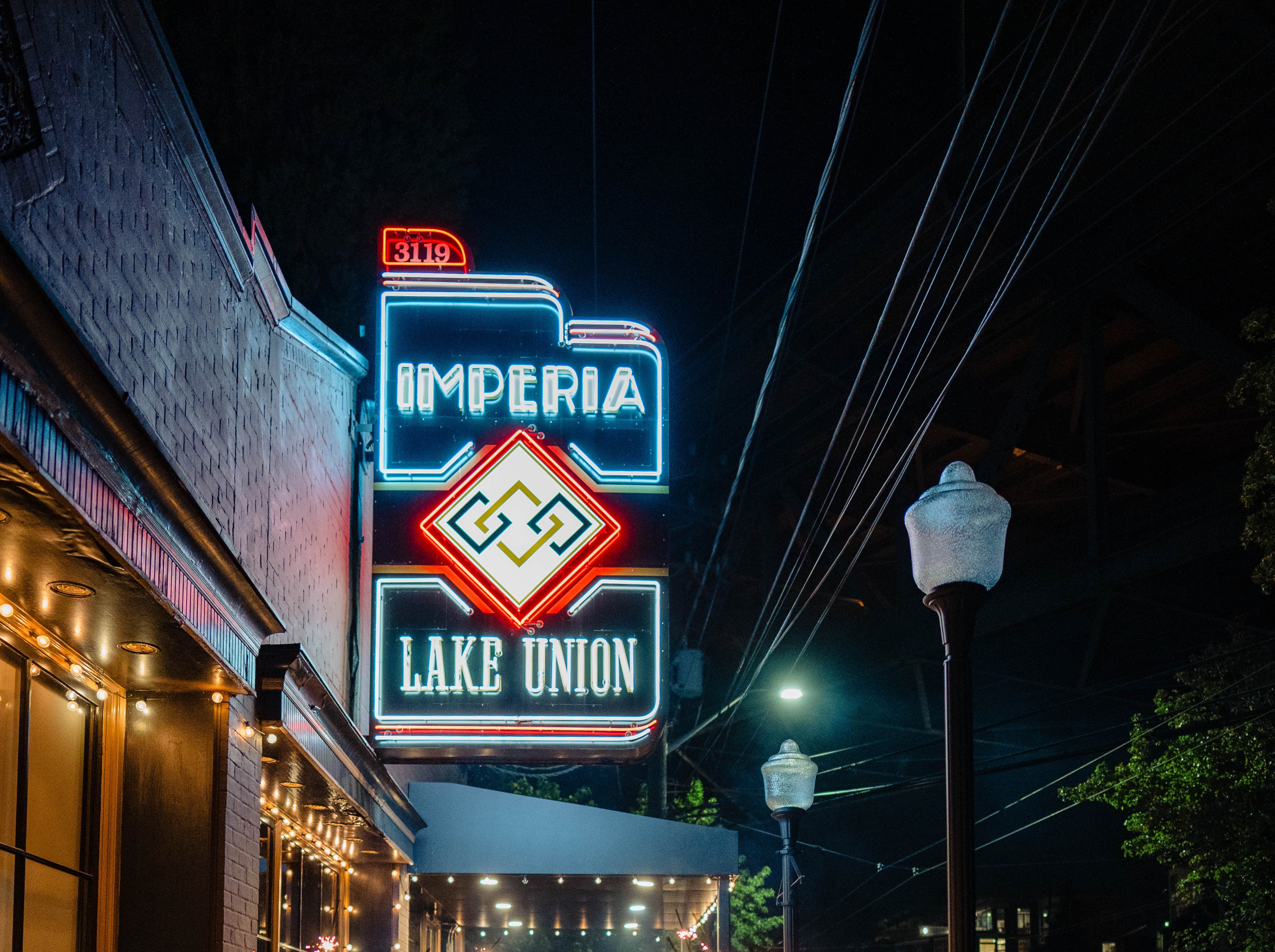 Imperia at Lake Union neon sign lit up at night