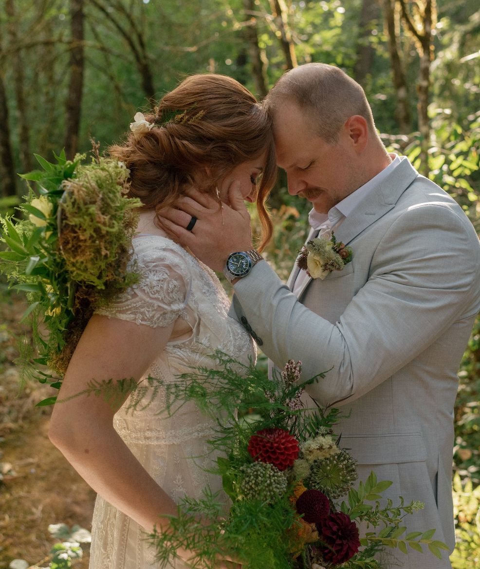 two brides smiling with handfuls of flowers