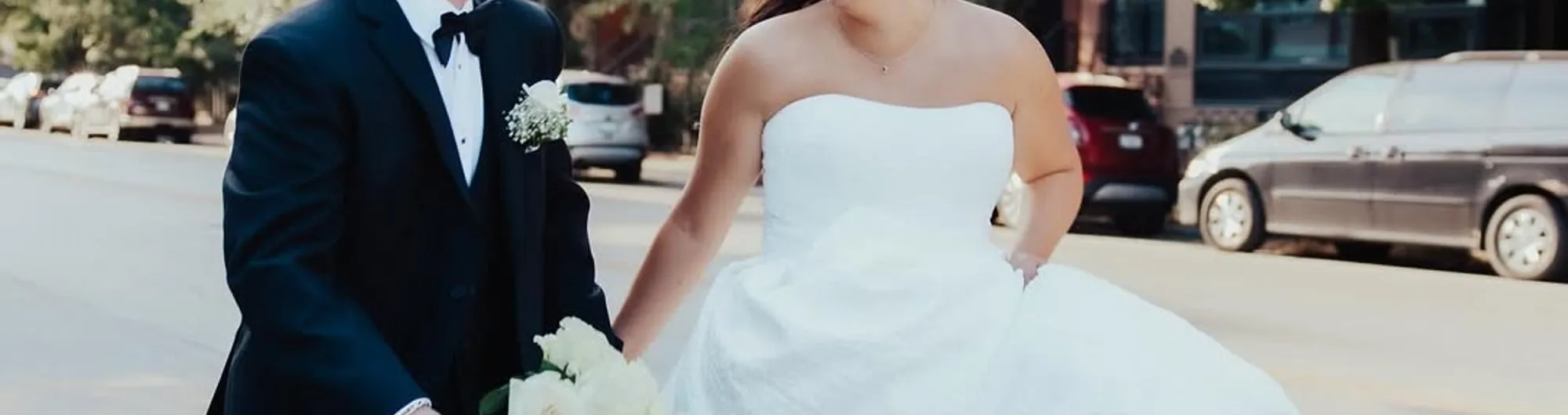 man and wife walking down the street in wedding atire