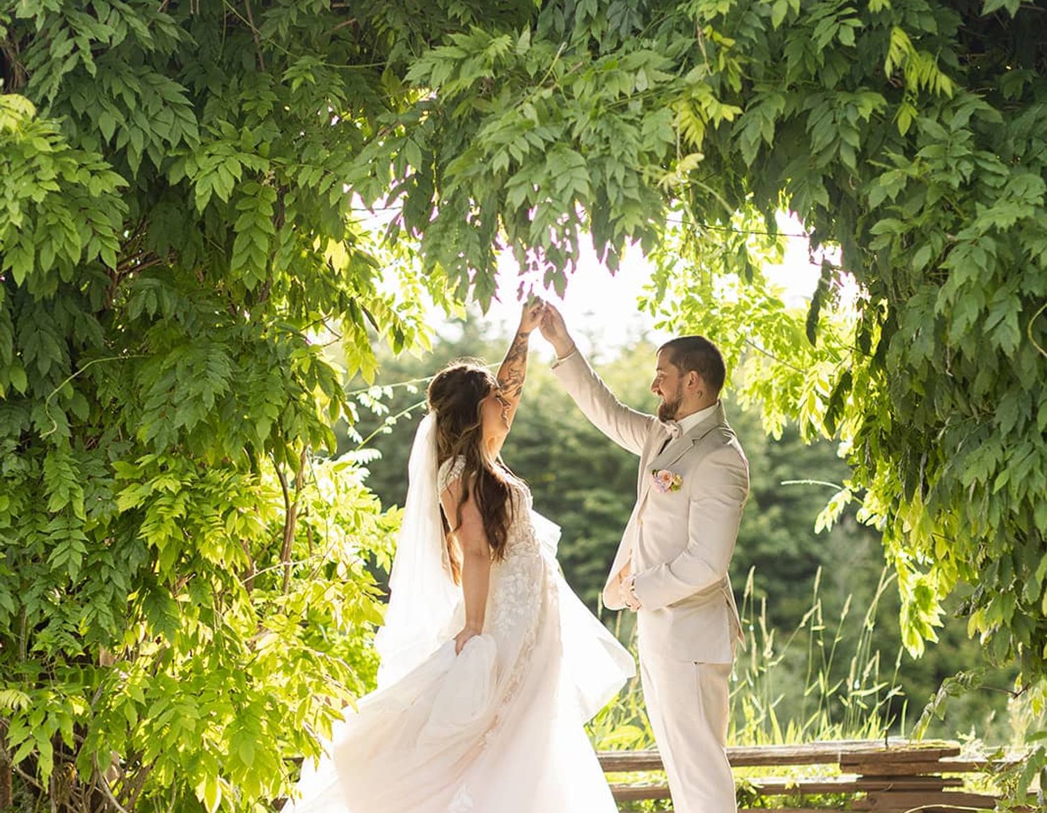 man in with bride in white dress looking into each others eyes