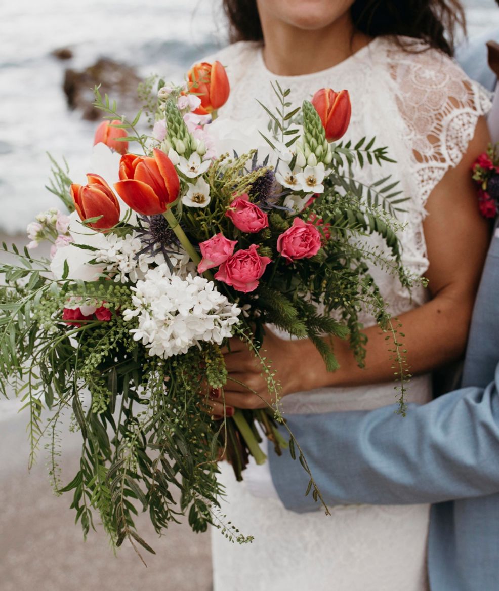 bride holding a handful of flowers