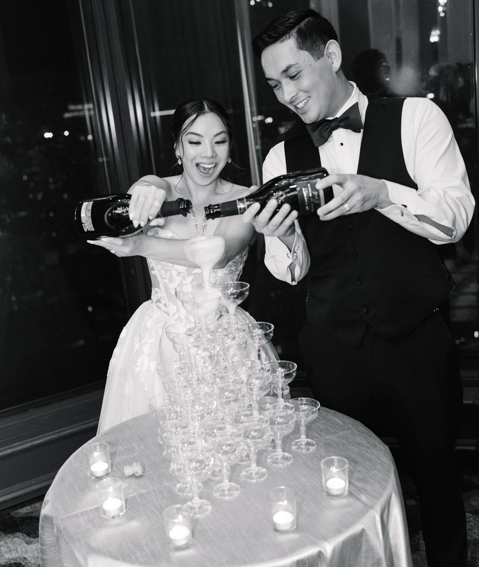 Champagne tower overflowing into wine glasses